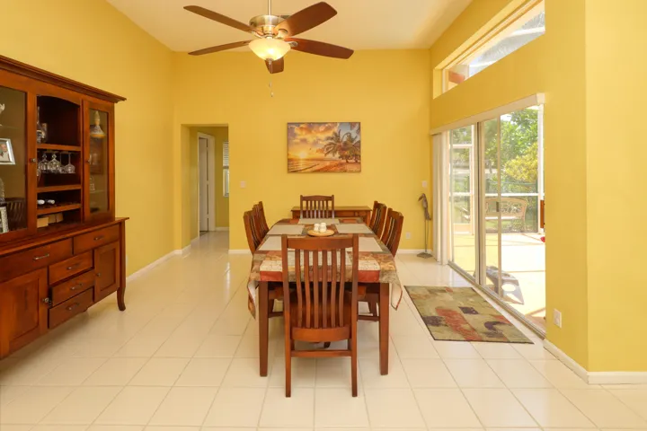 Open dining area featuring high ceilings and seamless flow to the family room and outdoor entertaining spaces.