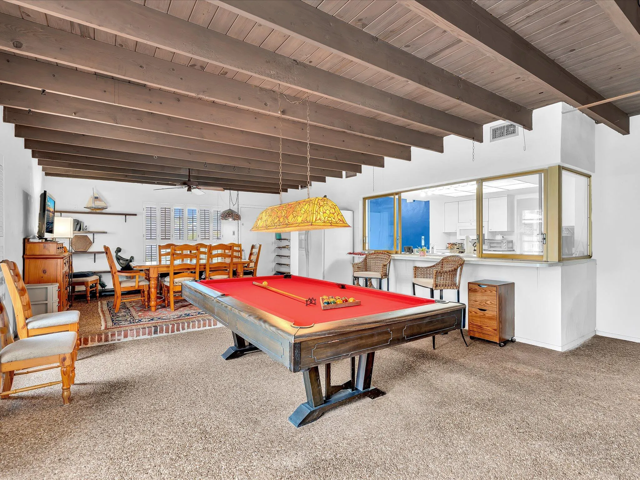 Exposed beam ceiling with wood-finish planks, recessed lighting, and a ceiling fan