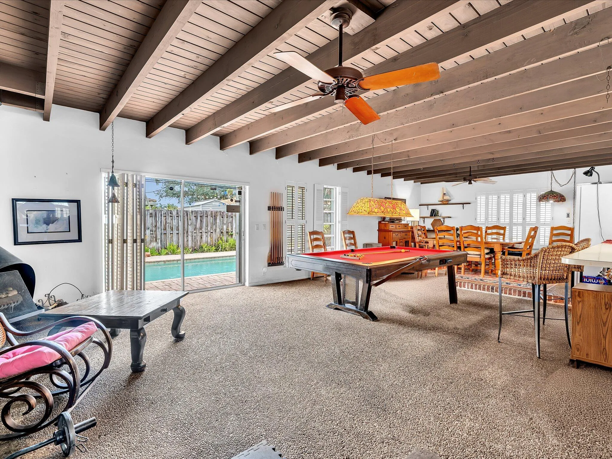 Spacious interior featuring exposed beam ceilings and textured flooring