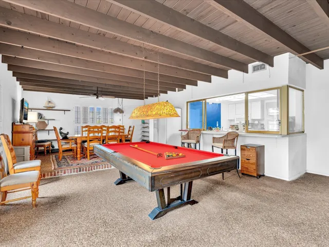 Exposed beam ceiling with wood-finish planks, recessed lighting, and a ceiling fan