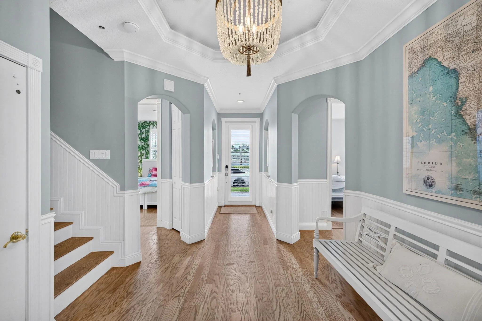 Foyer with high ceilings and wainscoting