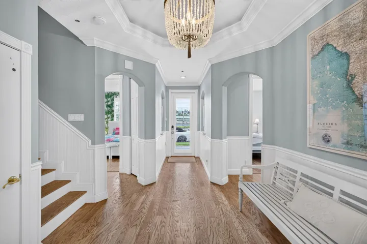 Foyer with high ceilings and wainscoting