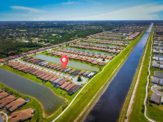 Expansive aerial perspective showcasing a residential community with multiple water features