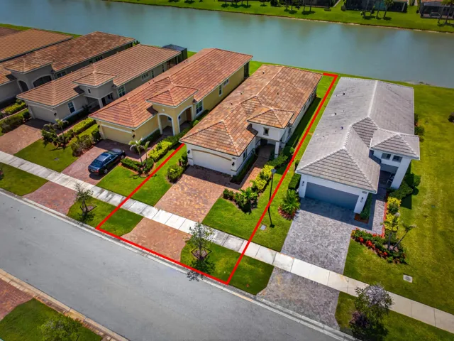 Contemporary exterior with an attached two-car garage, paver driveway, and manicured landscaping