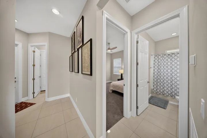 Hallway with recessed lighting, tile flooring, and neutral wall tones