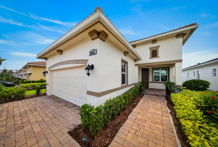 Stucco exterior featuring decorative corbels and a tile roof