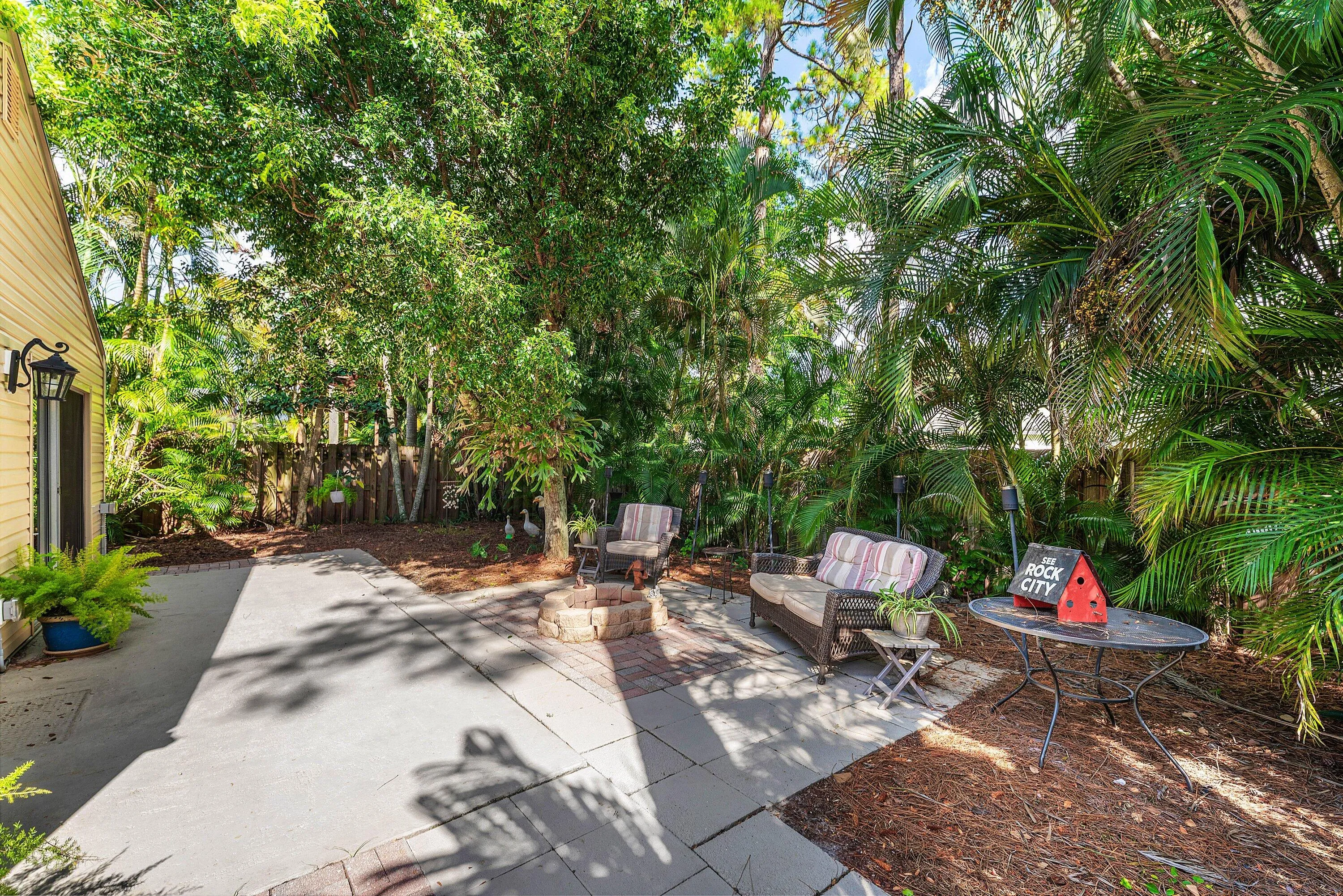 Expansive backyard featuring a concrete patio with paver accents