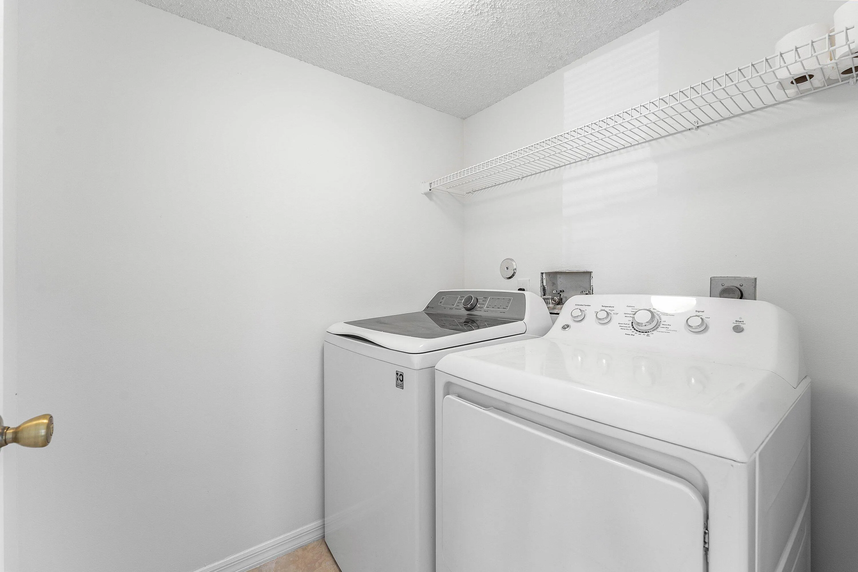 Dedicated laundry area featuring white appliances