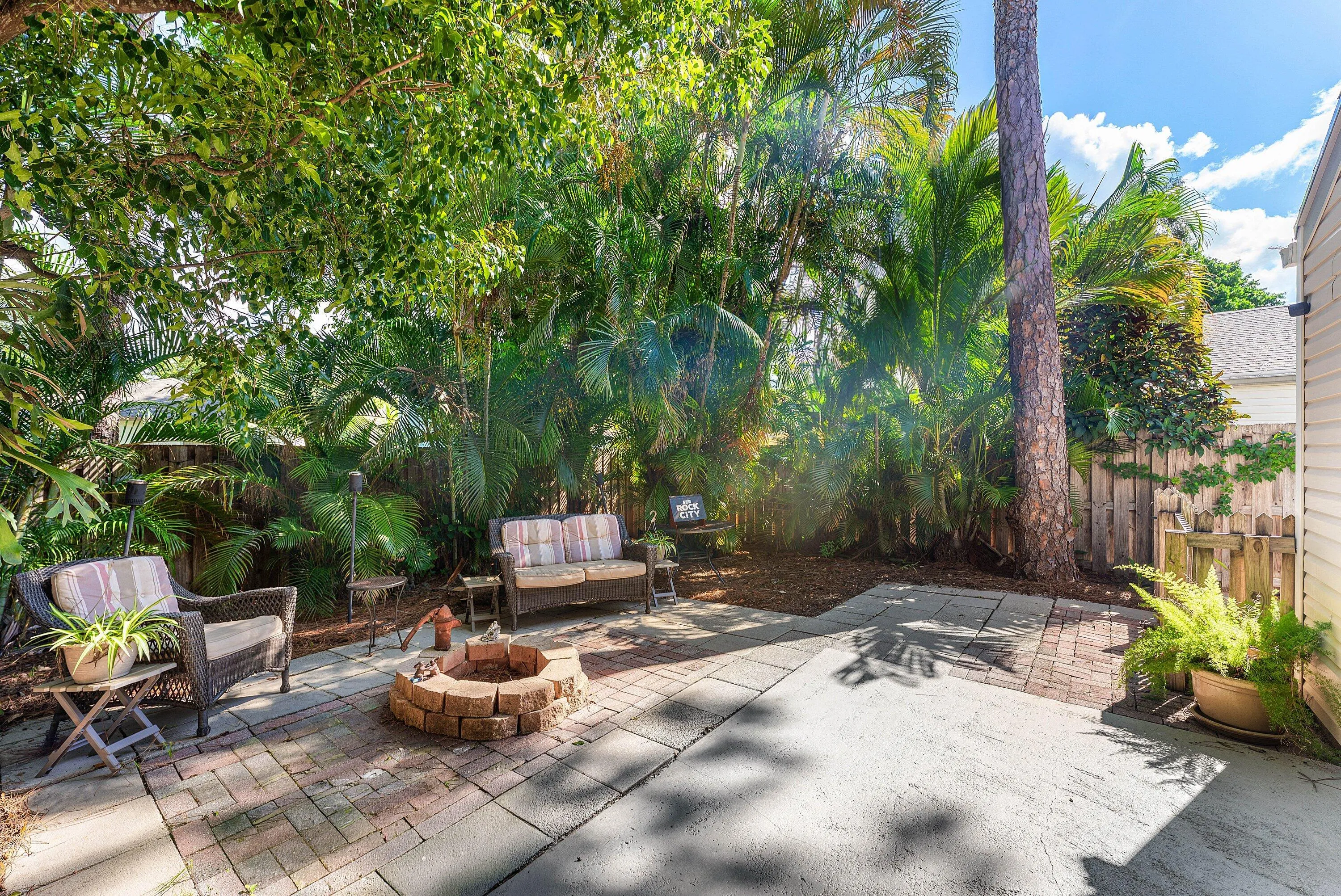Outdoor patio featuring a brick fire pit