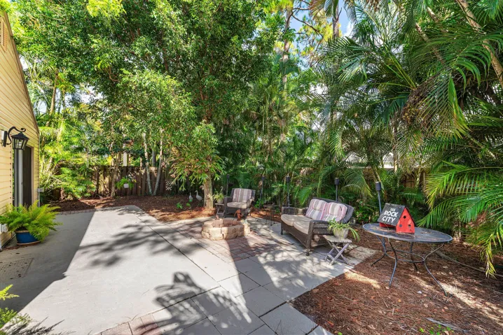 Expansive backyard featuring a concrete patio with paver accents