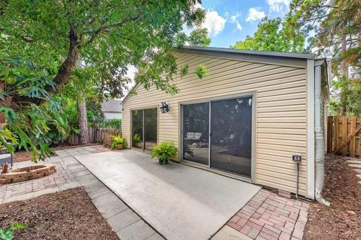 Inviting outdoor patio featuring a concrete slab and brick paver walkway