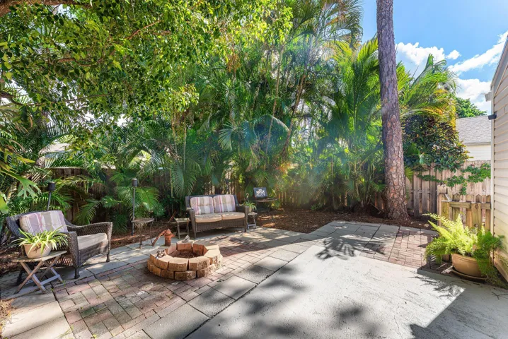 Outdoor patio featuring a brick fire pit