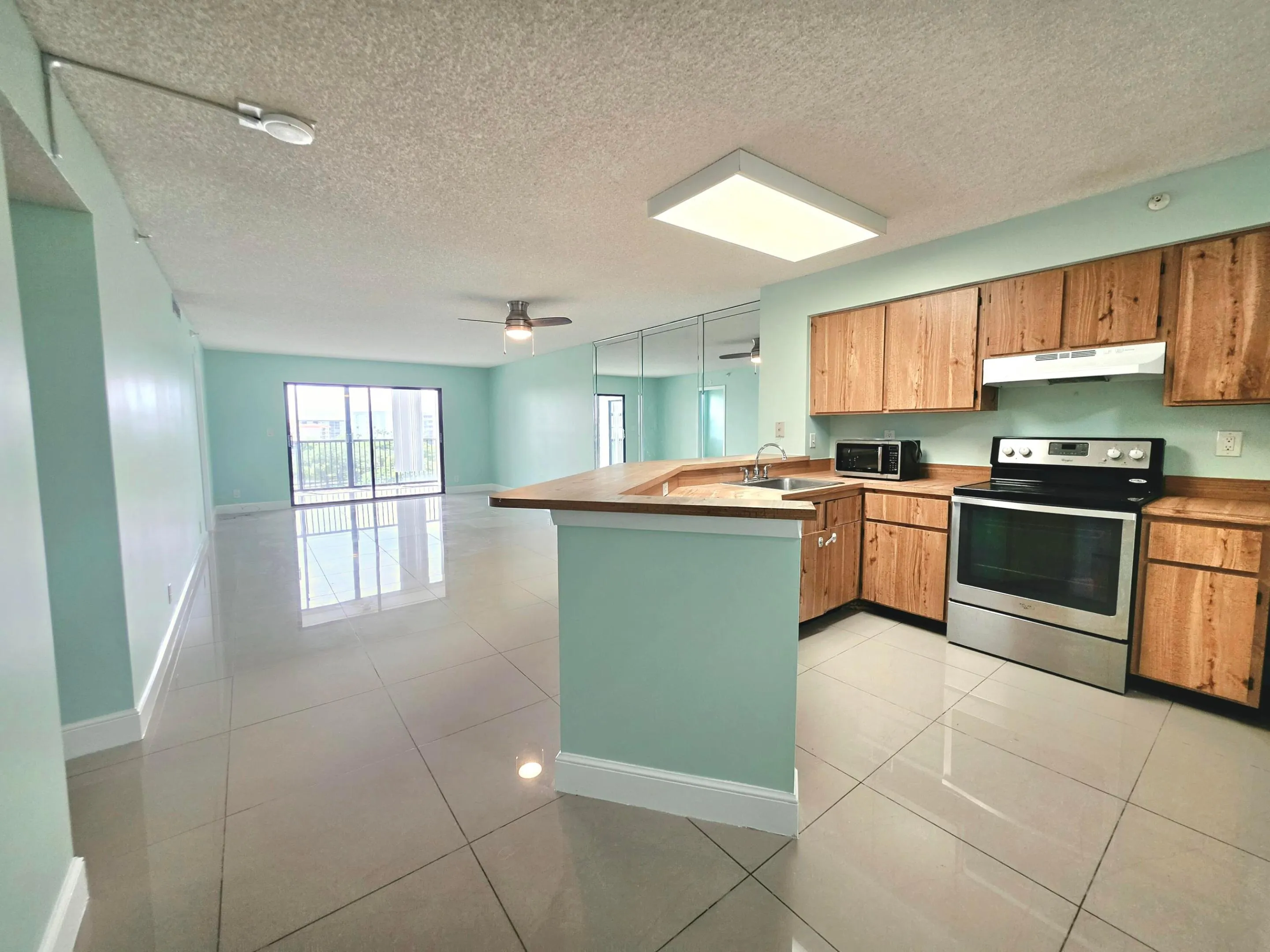 LARGE KITCHEN WITH LIVING ROOM/ DINING ROOM LEADING TO YOUR SPECTACULAR LAKE VIEW