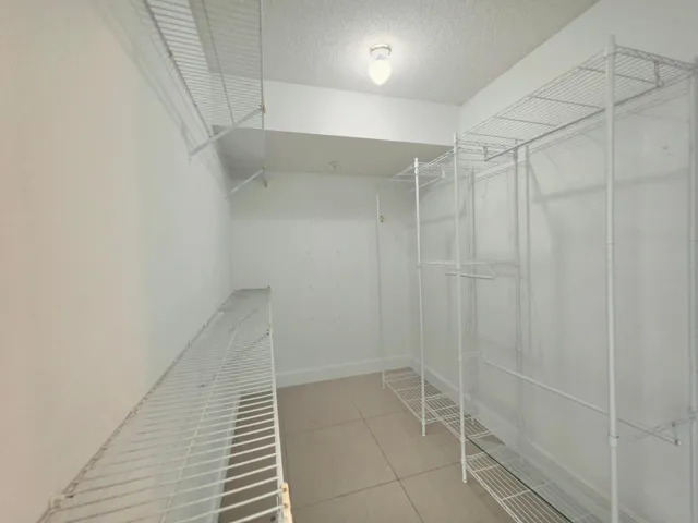 WALK-IN CLOSET IN THE PRIMARY BEDROOM
