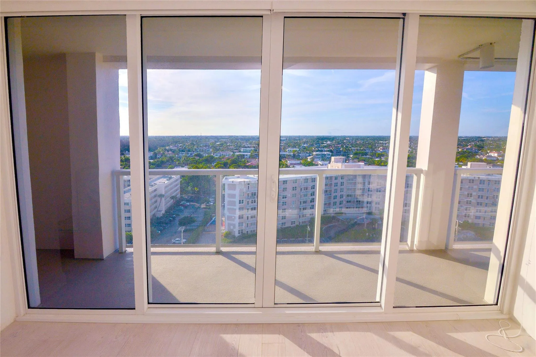 Expansive sliding glass doors opening to a private balcony