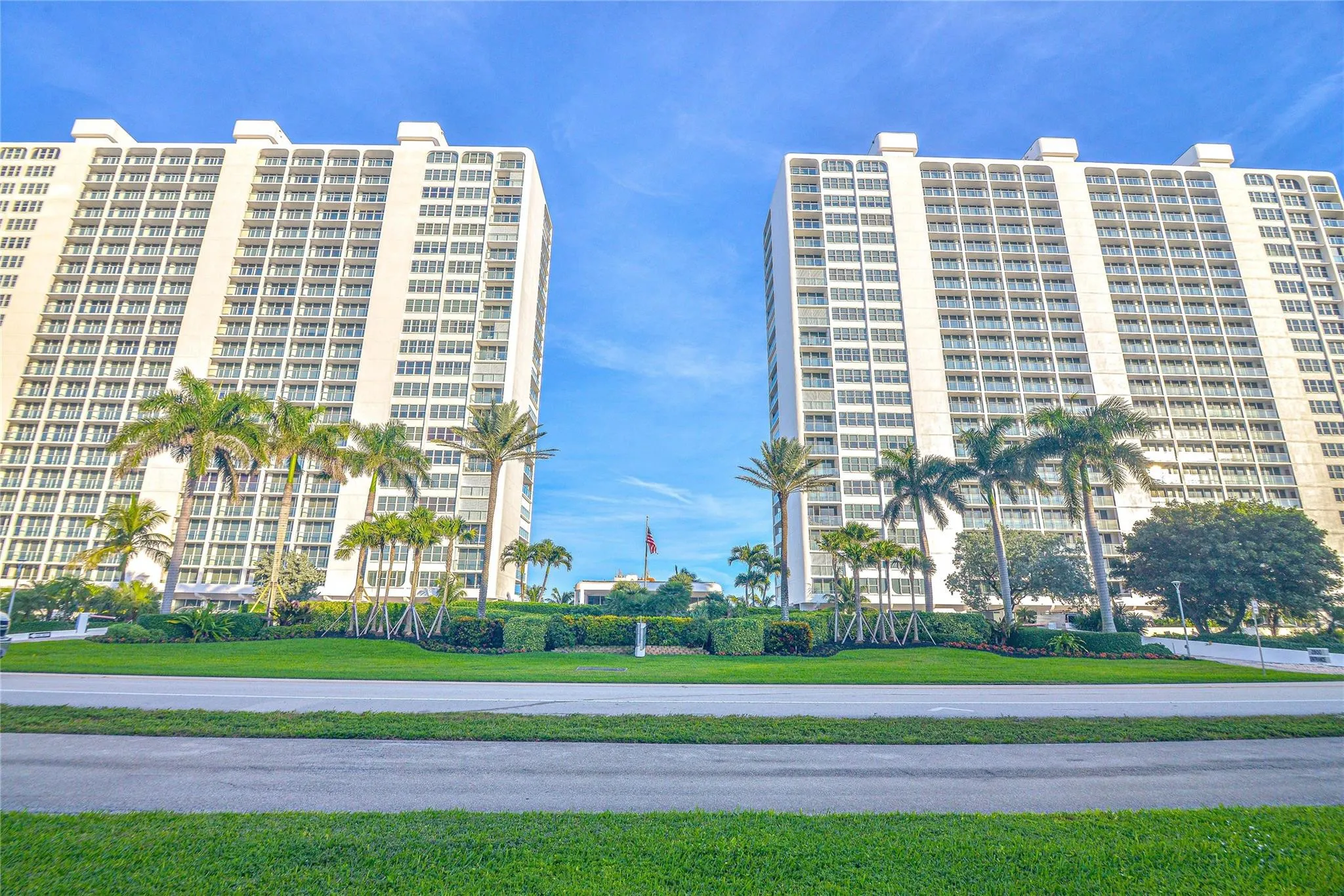 Twin high-rise structures featuring extensive balconies and numerous windows