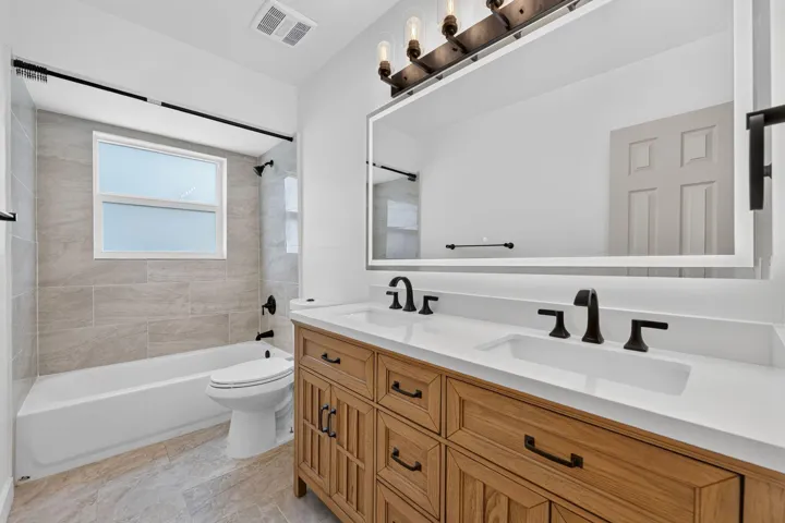 GUEST FULL BATH WITH DUAL SINKS AND SHOWER TUB COMBO