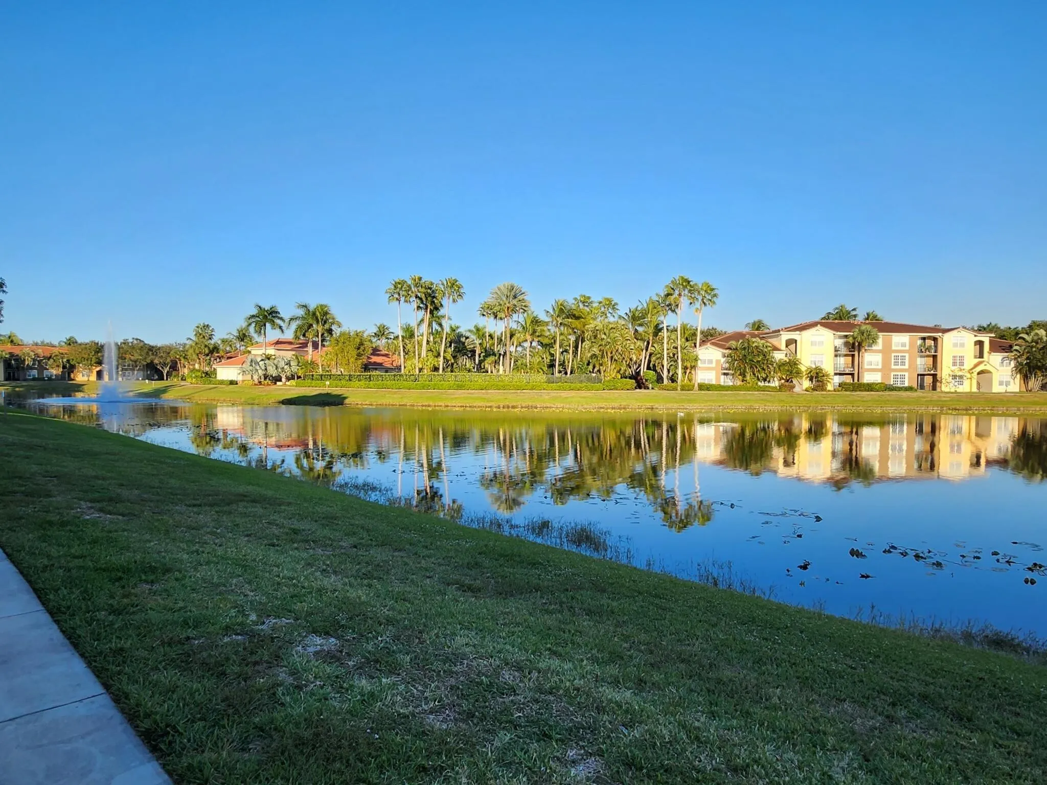 Waterfront property featuring a serene lake with a central fountain