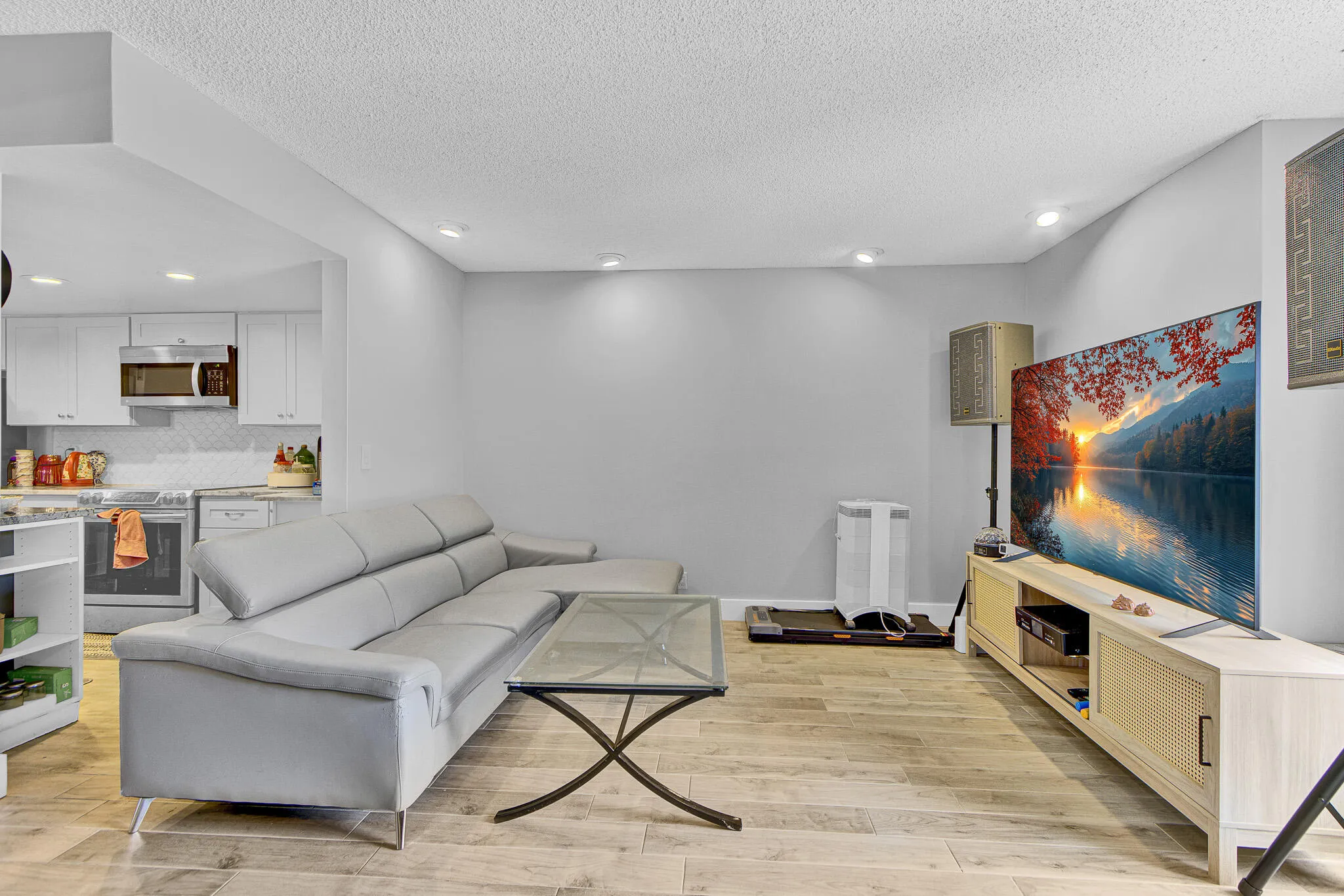Open-concept living space featuring wood-finish flooring and recessed lighting