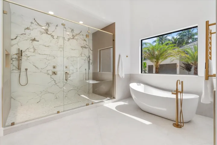 10 ft shower with dual rainfosrest starions and bookend matched porcelain wall accent. Soaking tub and heated towel rack