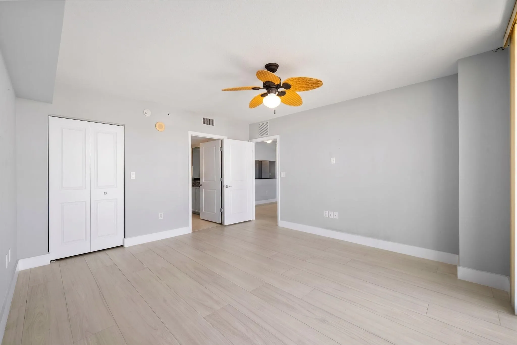 Alternate view showcasing the main suite’s spacious proportions, custom-fitted walk-in closet & direct access to the ensuite bath.