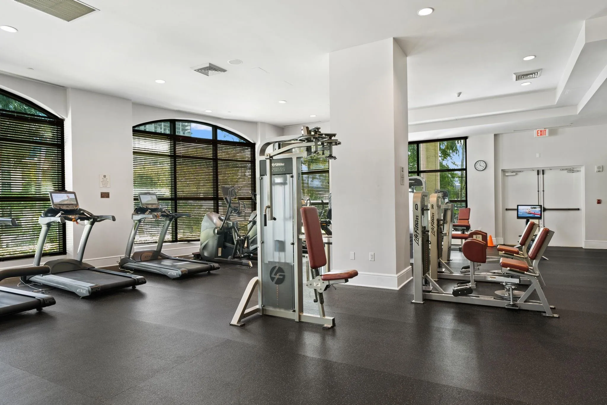Spacious fitness center offering a broad selection of cardio & strength-training equipment, natural light & New River views.