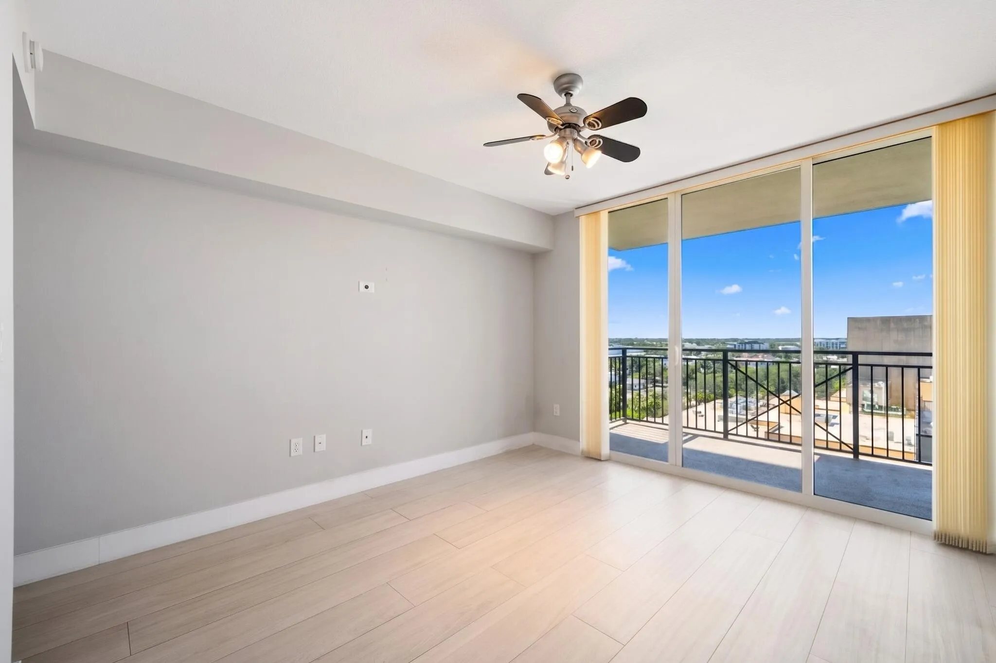 Alternate view of the second suite highlighting abundant natural light, large sliding glass doors & direct terrace access.