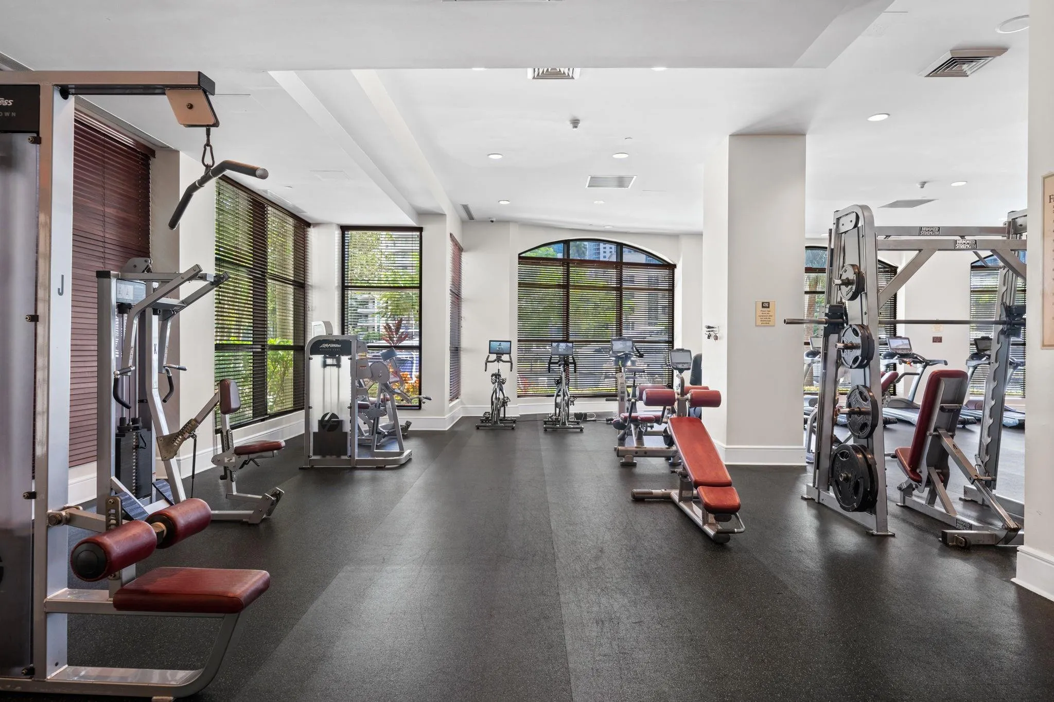 Fully equipped fitness center with treadmills, cardio equipment, strength-training machines & large windows overlooking the New River.