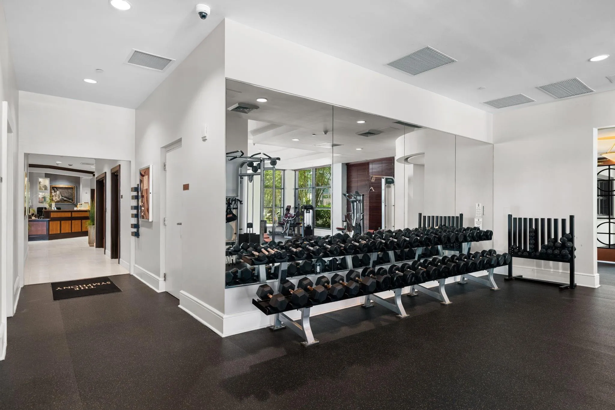 Dedicated free-weight area with dumbbells, mirrored walls & convenient access to the spa and salon.