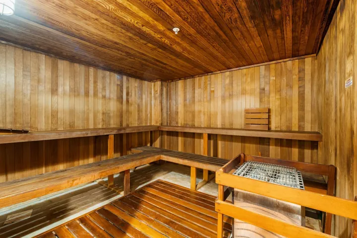 Wood-paneled sauna with tiered bench seating, part of The Symphony’s on-site wellness amenities.