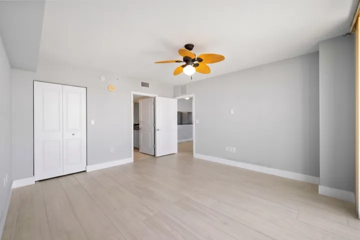 Alternate view showcasing the main suite’s spacious proportions, custom-fitted walk-in closet & direct access to the ensuite bath.