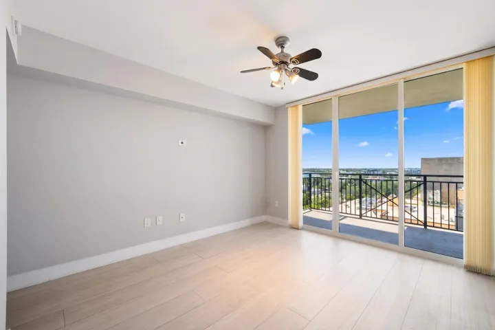 Alternate view of the second suite highlighting abundant natural light, large sliding glass doors & direct terrace access.
