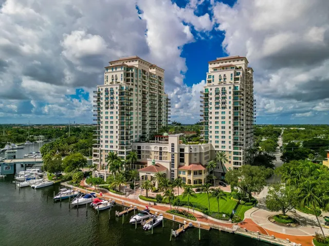 Aerial overview of The Symphony’s towers, resort-style pool deck, private marina & exceptional New River setting.