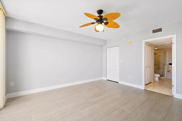 Additional view of the bright main suite, offering a flexible furniture layout, ceiling fan & private ensuite bath.
