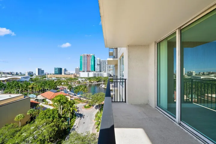 Alternate terrace view showcasing the covered outdoor space, sliding glass doors & elevated Fort Lauderdale surroundings.