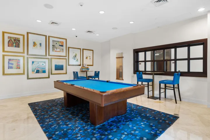Resident club room featuring billiards, bar-height seating & a relaxed setting for entertaining or game nights.