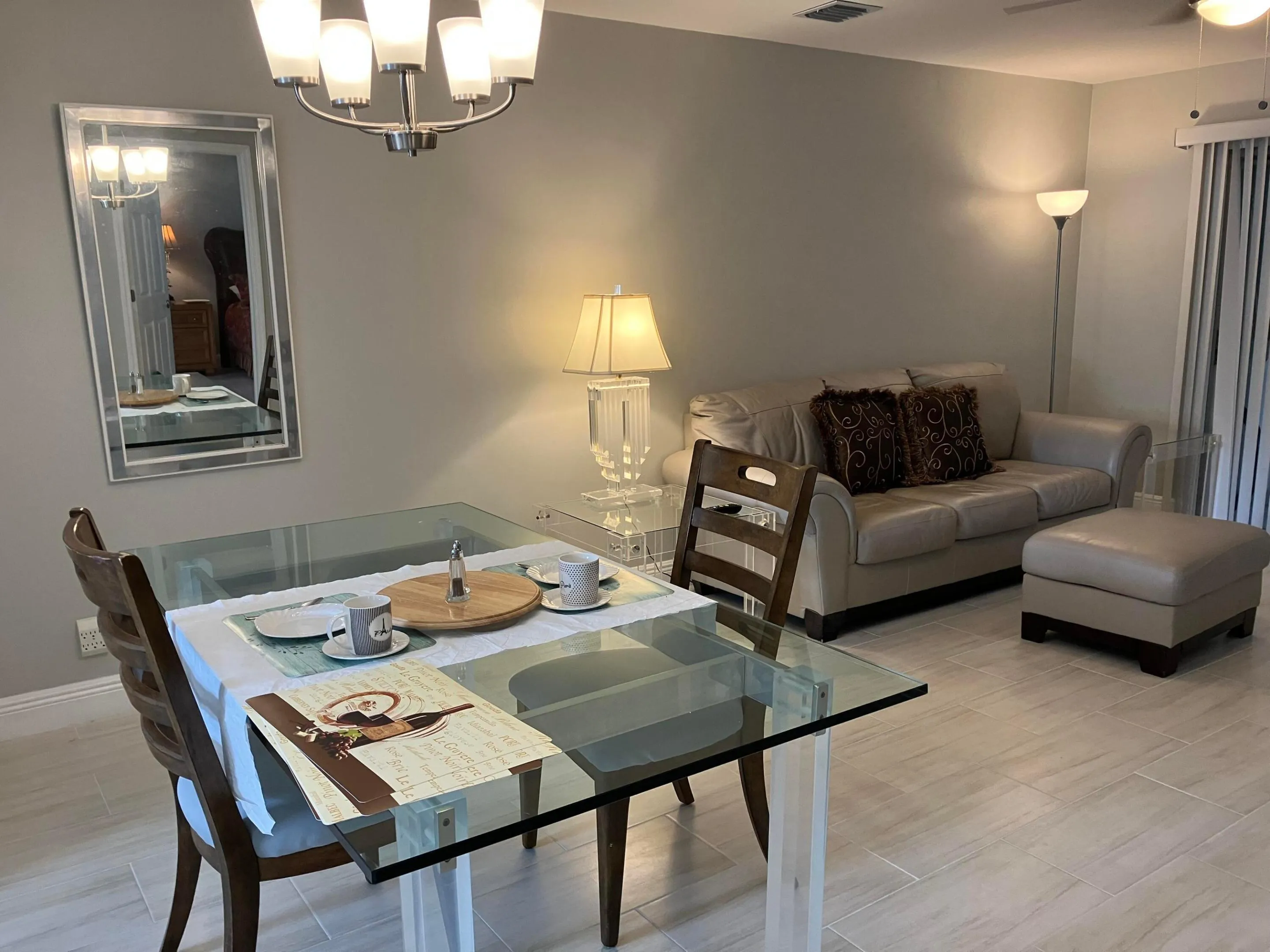 Open-concept living area with light-toned walls and tile flooring