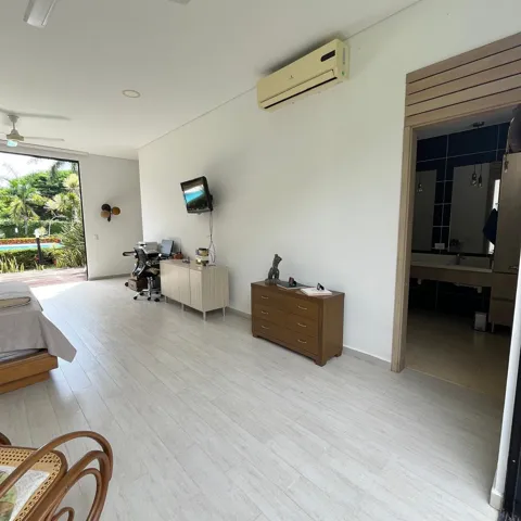 Spacious room featuring light wood-finish flooring and a direct access point to an outdoor area