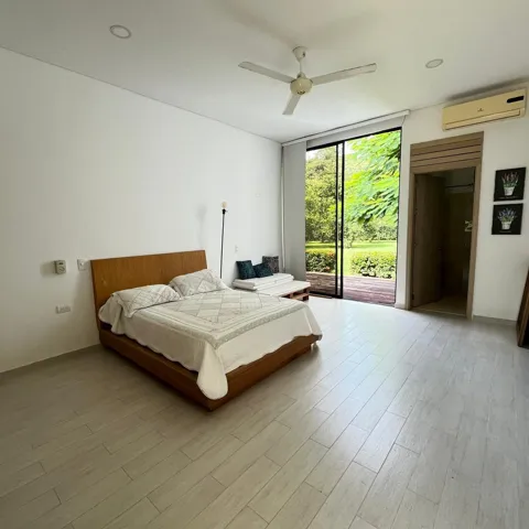 Spacious room featuring light wood-finish flooring and a direct access point to an outdoor area