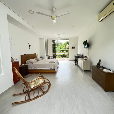 Spacious room featuring light wood-finish flooring and recessed lighting. Master bedroom with walk-in closet and private bathroom