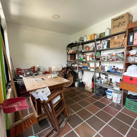 Utility room featuring terracotta-hued tile flooring, white walls, and a recessed ceiling light