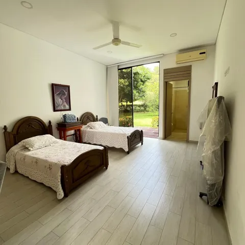 Spacious room featuring wood-finish plank flooring, a ceiling fan, recessed lighting, and a large glass door providing direct outdoor access