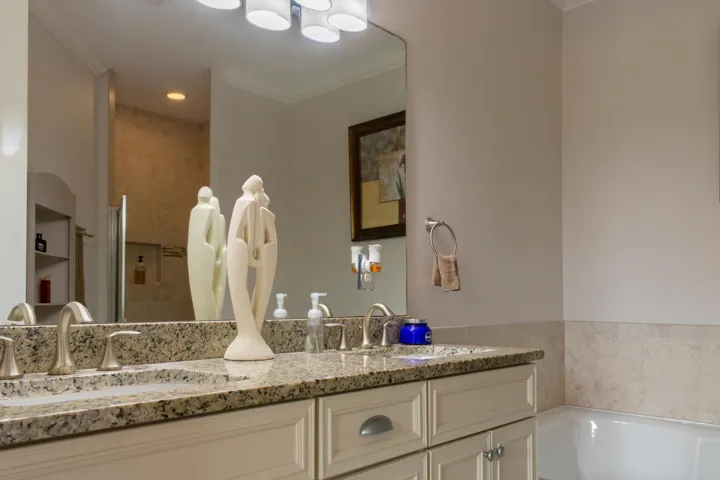 Granite-finish dual vanity with undermount sinks and brushed nickel faucets