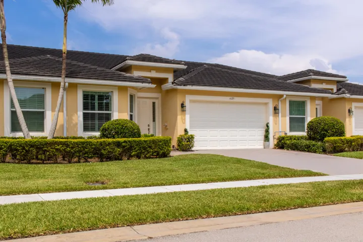 Stucco exterior with a tiled roof and an attached two-car garage