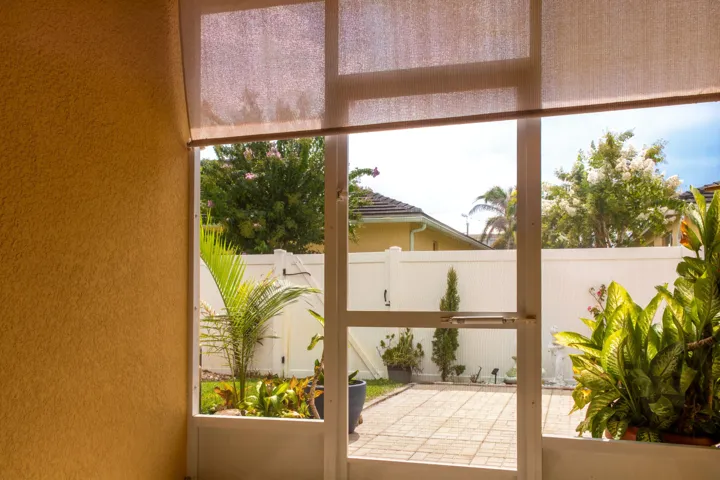 Enclosed patio space overlooking a private back yard