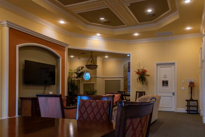 Spacious interior with an intricate coffered ceiling, recessed lighting, and crown molding