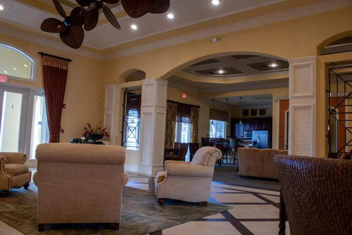 Spacious common area featuring an arched entryway, coffered ceiling, and recessed lighting