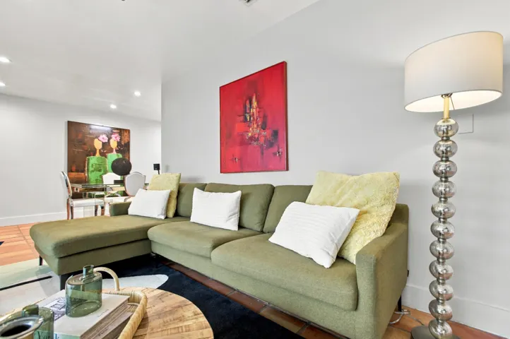 Open-concept living area with light-toned wall paint and recessed lighting