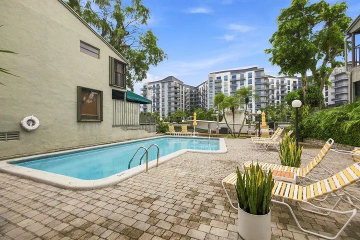 Rectangular pool with integrated steps set within a paver patio