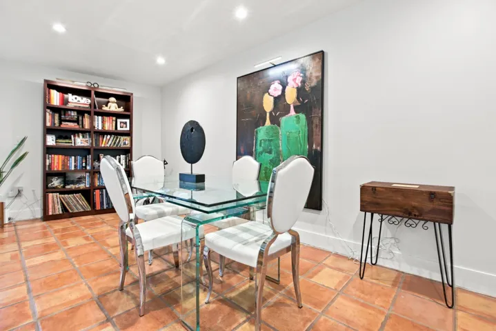 Terra cotta tile flooring throughout a bright room with recessed lighting